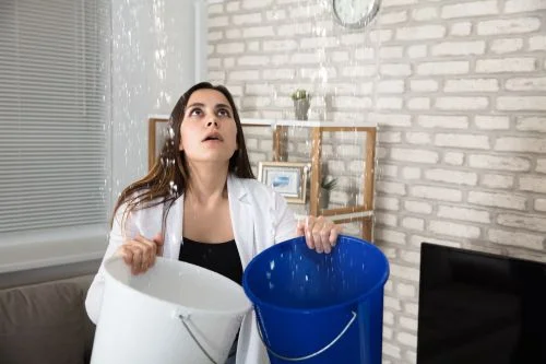 Woman catching leak