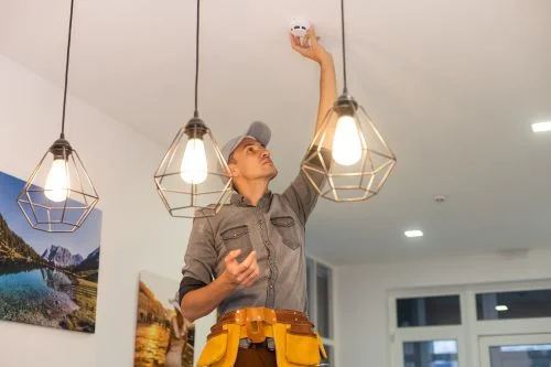 Man checking smoke detector